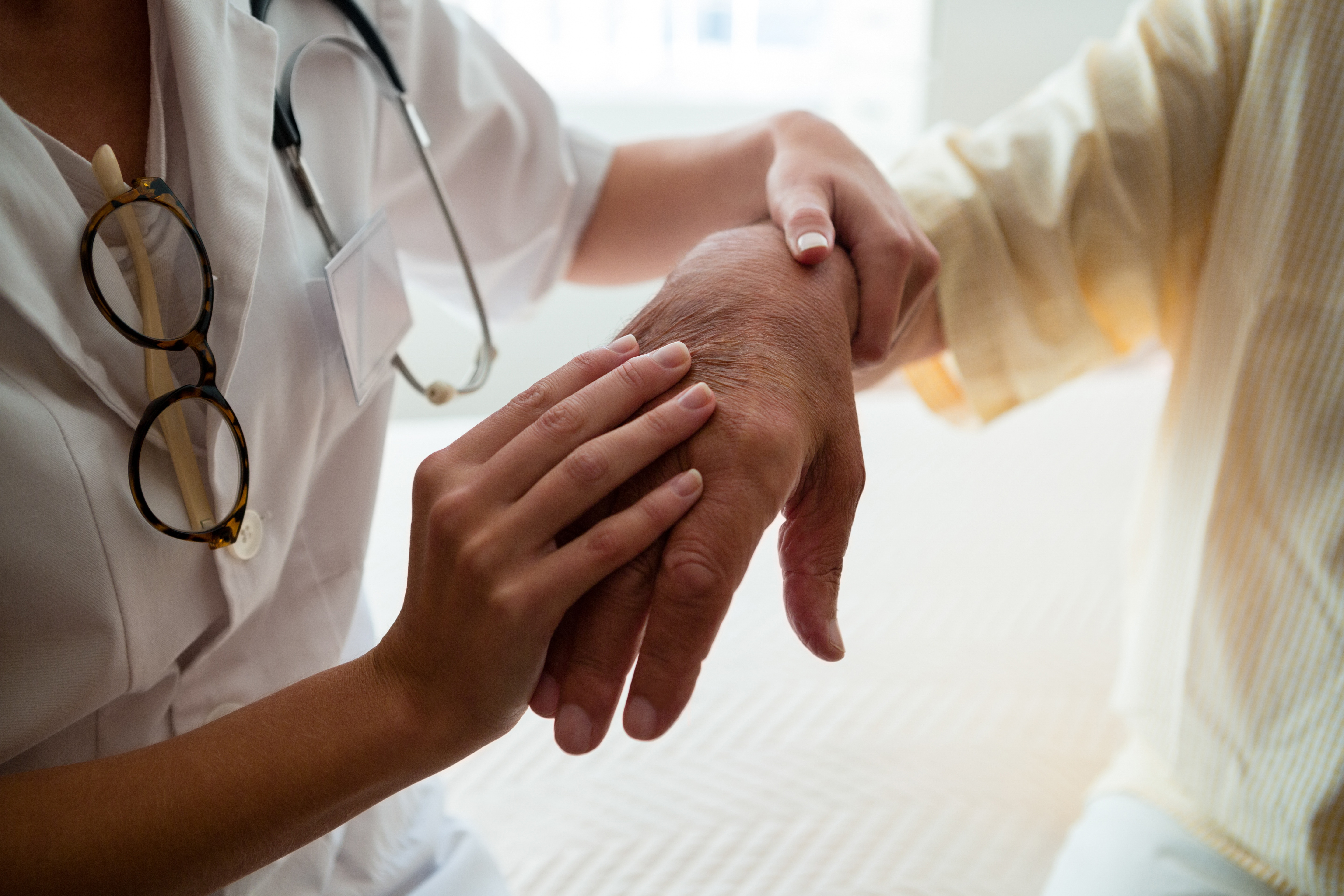 Doctor examining a patient's hand.